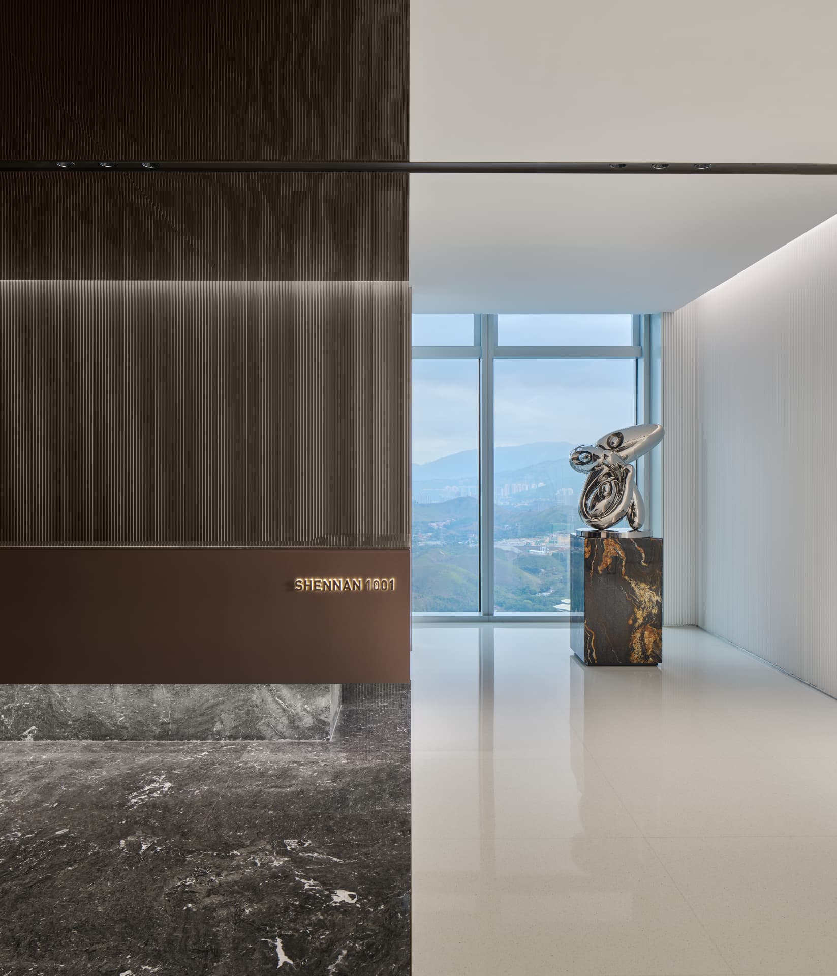 No.1 Shennan Road — Shenzhen, China: No.1 Shennan Road, Shenzhen — lobby detail with backlit signage and sculpture