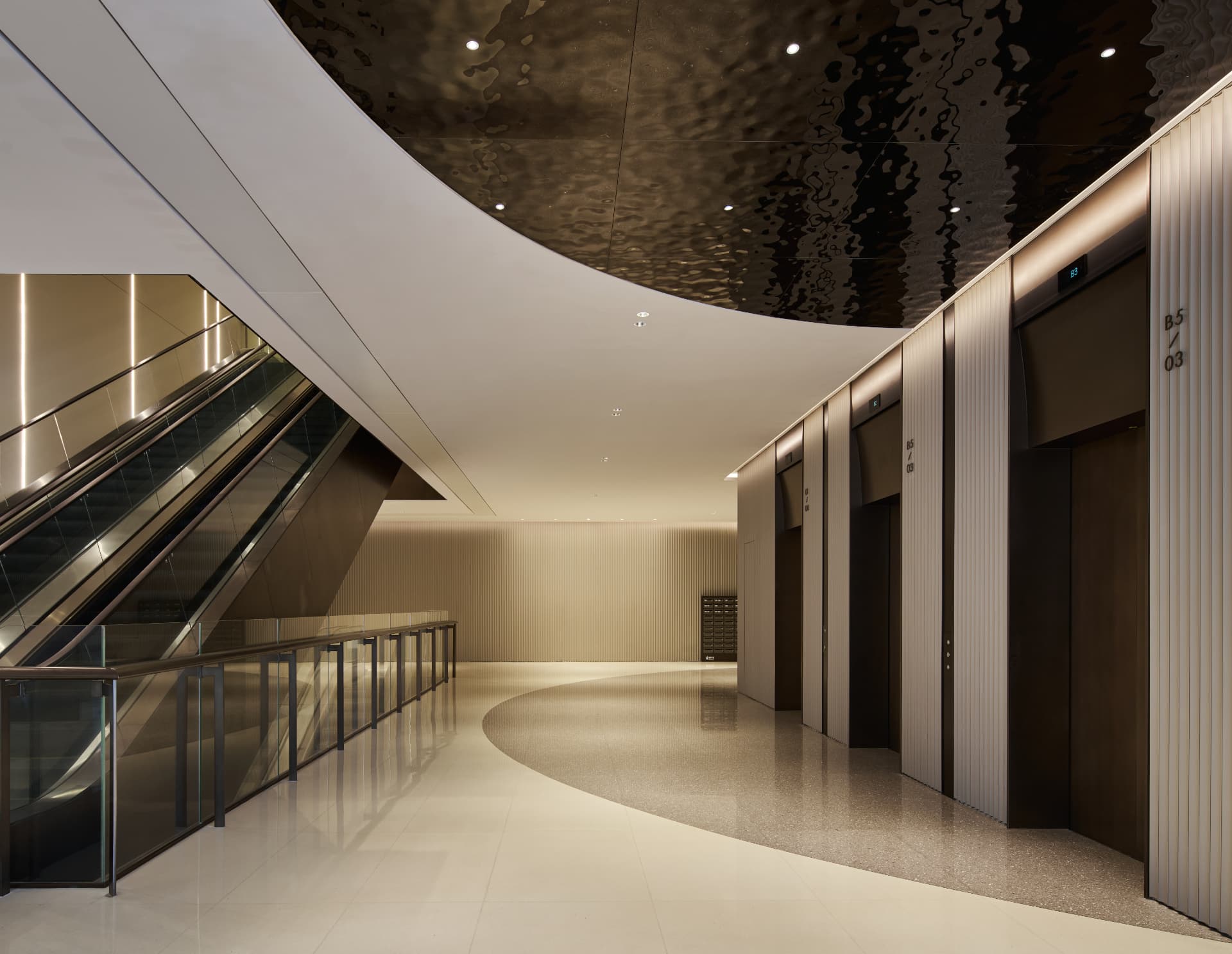 No.1 Shennan Road — Shenzhen, China: No.1 Shennan Road, Shenzhen — escalator hall with curved ceiling and lift lobby