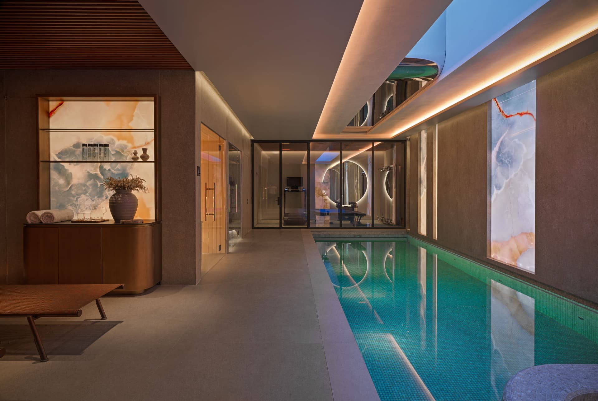 Clifton Hill — London, United Kingdom: Indoor pool and spa at Clifton Hill with lit skylight and onyx panels