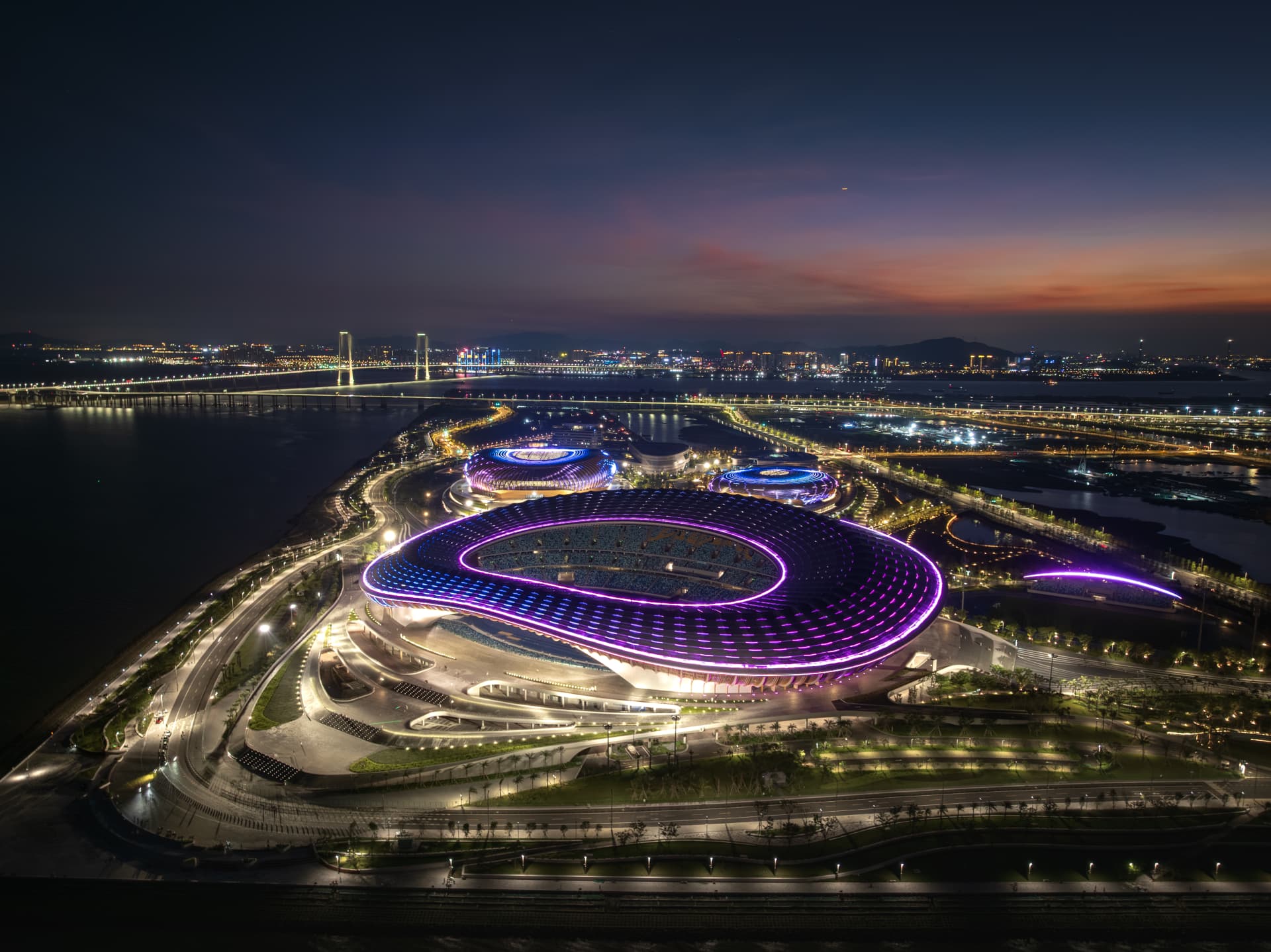 Estadio Nan Sha — Guangzhou, China: Nan Sha Stadium, Guangzhou — main stadium roof in violet and blue light