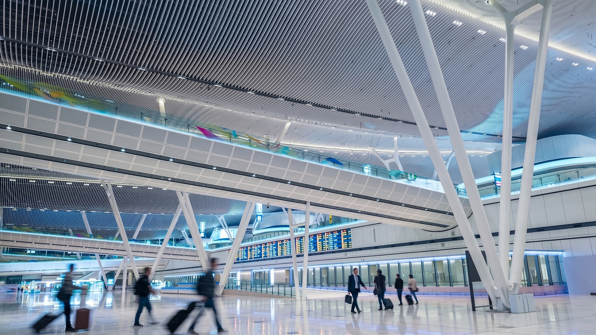 Hong Kong International Airport – Terminal 2 — Hong Kong, China: Hong Kong International Airport Terminal 2 — upper level walkway with linear ceiling light, Lichtvision lighting design